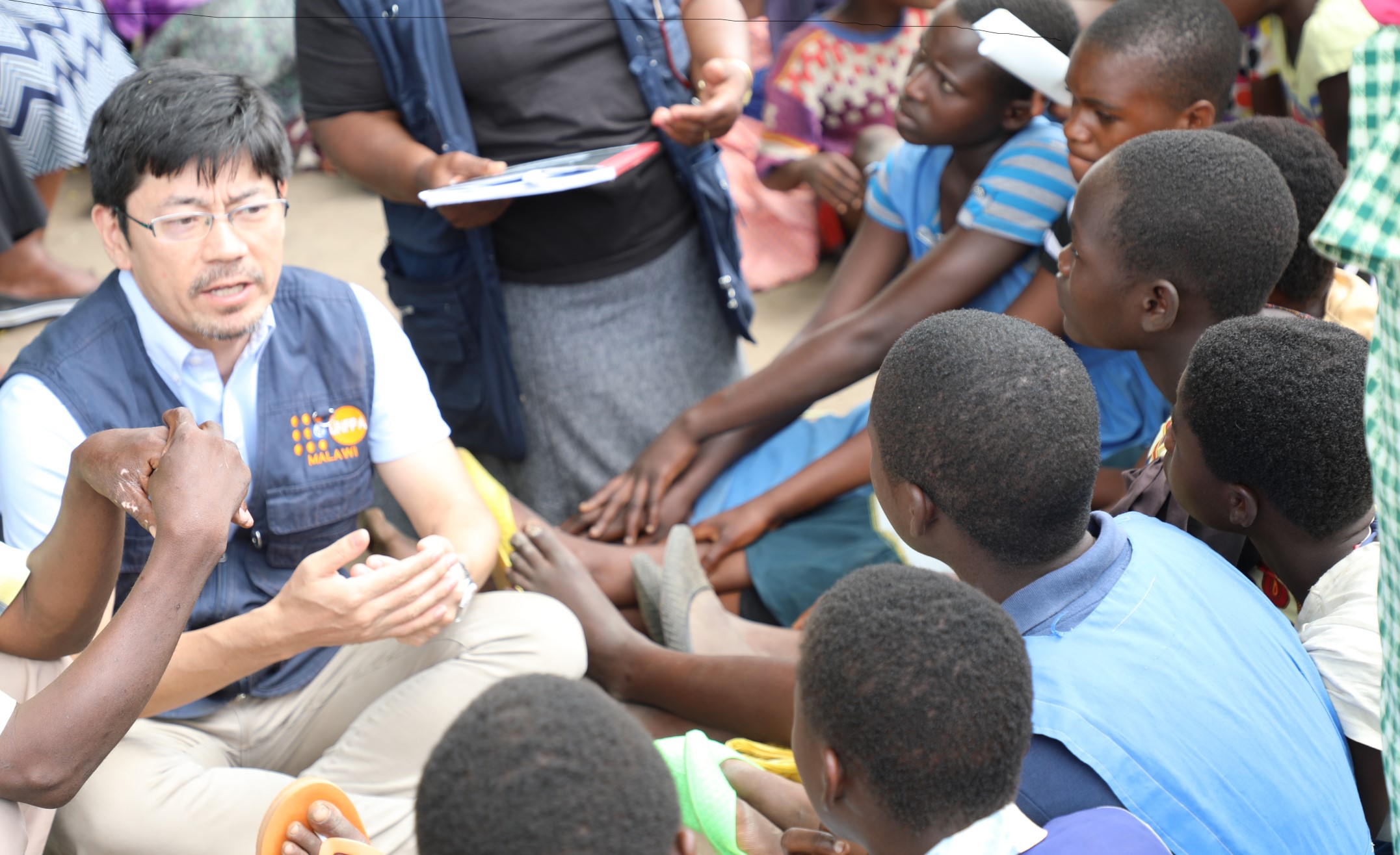 Masaki Watabe, UNFPA Deputy Representative engaging with adolescent girls before they received the dignity kits