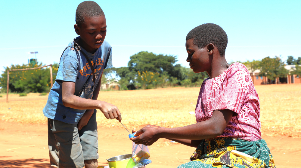 Colleta serving a customer ©UNFPA/2024/Joseph Scott