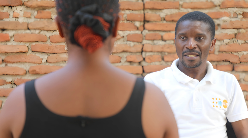 A UNFPA staff member engages Patuma during a one to one session on comprehensive sexuality education ©UNFPA/Joseph Scott