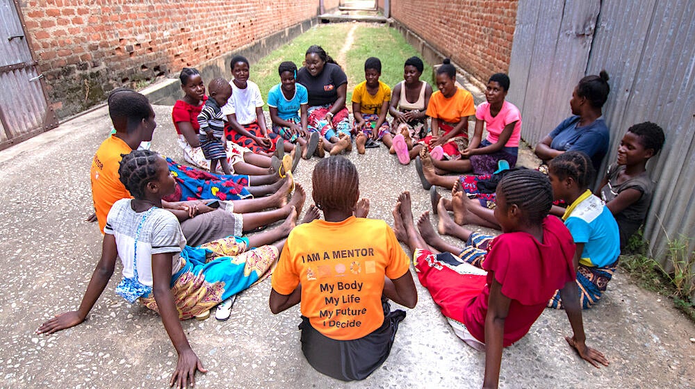 Young women, including adolescent parents, gather at a UNFPA Safe Space in Bangula camp in the aftermath of Cyclone Freddy. 