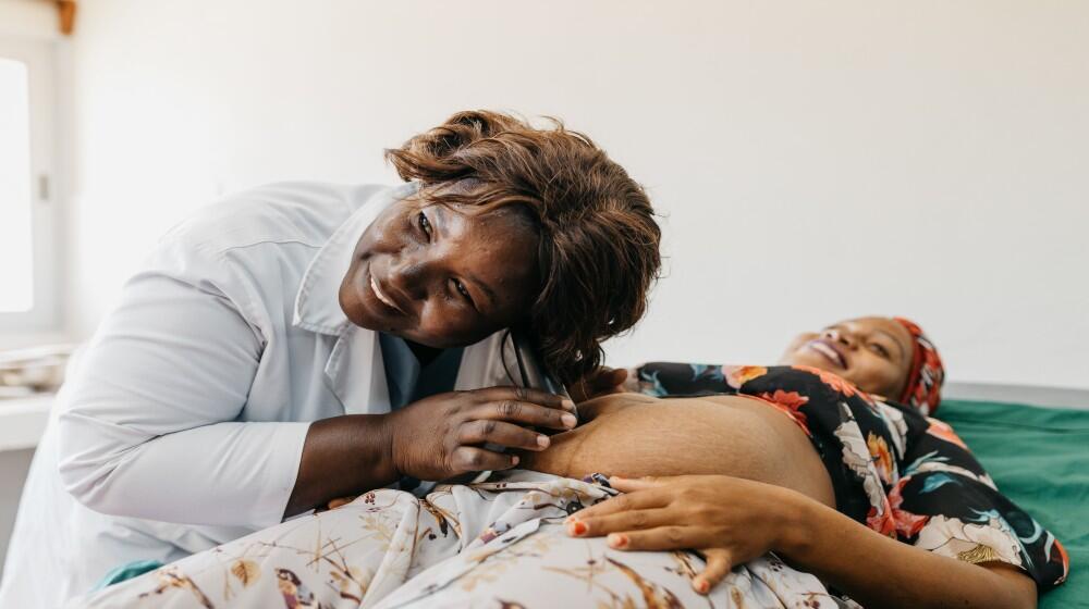 Midwifery: Nurse Edna Hilario performing Auscultation of Firosa's baby during her pregnancy consultation.
